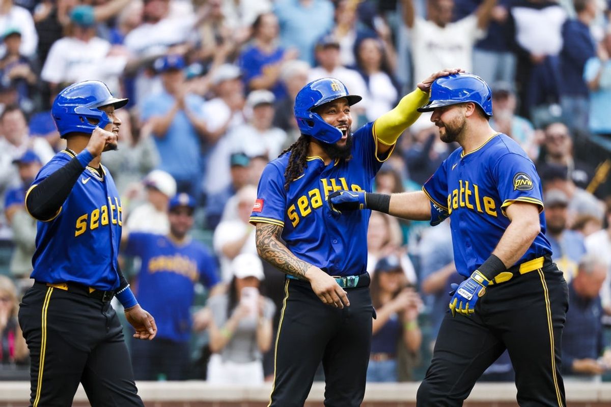 May 30, 2025; Seattle, Washington, USA; Seattle Mariners catcher Cal Raleigh (29, right) celebrates with shortstop J.P. Crawford (3, middle) and designated hitter Jorge Polanco (7, left) after hitting three-run home run against the Minnesota Twins during the first inning at T-Mobile Park. Mandatory Credit: Joe Nicholson-Imagn Images