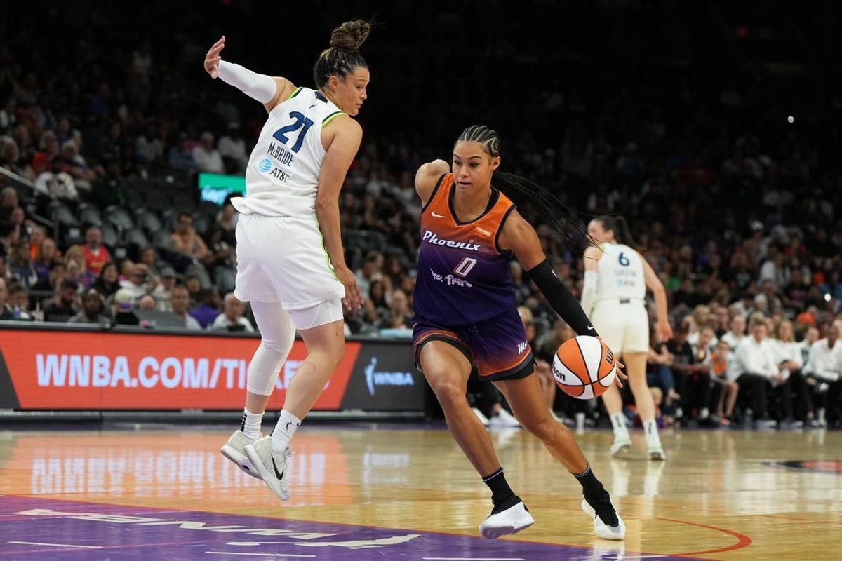 May 30, 2025; Phoenix, Arizona, USA; Phoenix Mercury forward Satou Sabally (0) drives past Minnesota Lynx guard Kayla McBride (21) in the first half at Footprint Center. Mandatory Credit: Rick Scuteri-Imagn Images