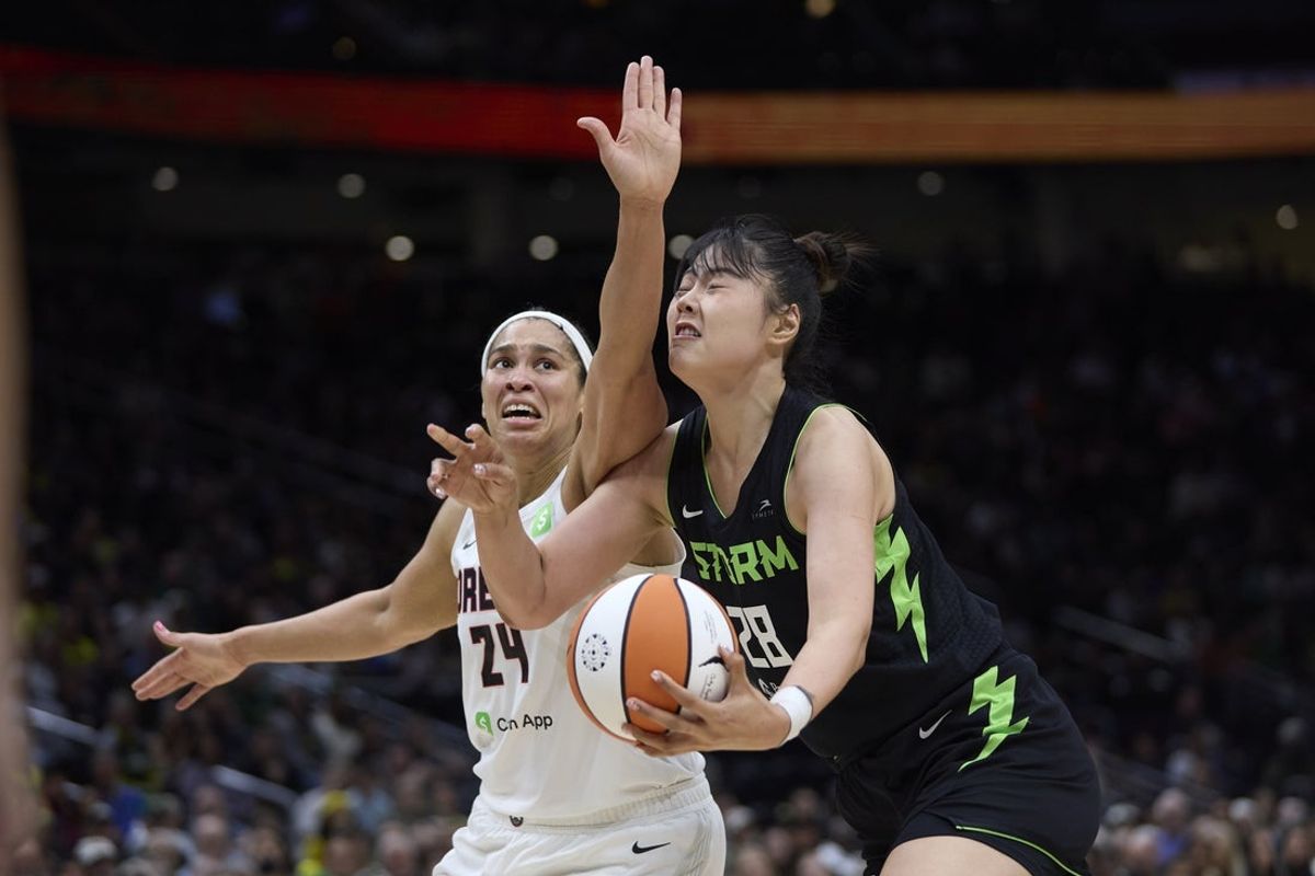 May 30, 2025; Seattle, Washington, USA; Seattle Storm center Li Yueru (28) is fouled by Atlanta Dream forward Brionna Jones (24) during the first half at Climate Pledge Arena. Mandatory Credit: John Froschauer-Imagn Images