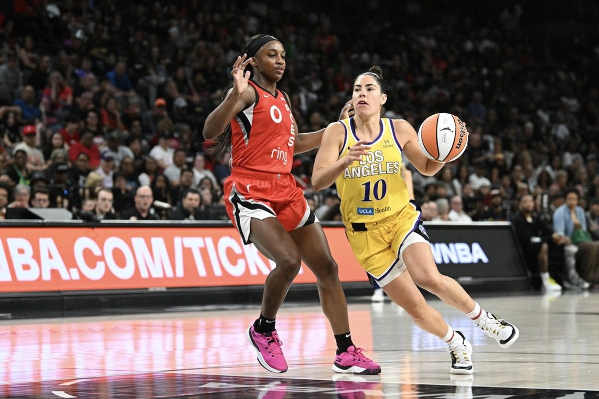May 30, 2025; Las Vegas, Nevada, USA; Los Angeles Sparks guard Kelsey Plum (10) drives past Las Vegas Aces guard Jackie Young (0) in the fourth quarter of their game at Michelob Ultra Arena. Mandatory Credit: Candice Ward-Imagn Images