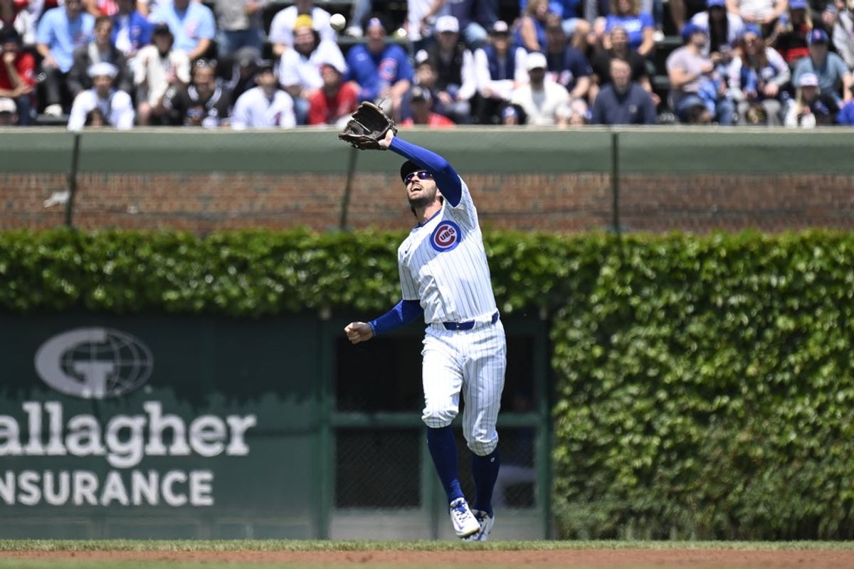 May 31, 2025; Chicago, Illinois, USA;  Chicago Cubs shortstop Dansby Swanson (7) catches a fly ball hit by Cincinnati Reds outfielder TJ Friedl (29) during the first inning at Wrigley Field. Mandatory Credit: Matt Marton-Imagn Images