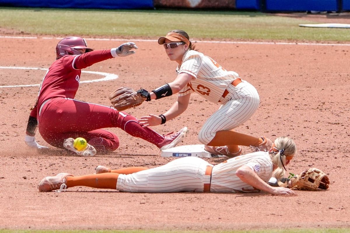 Oklahoma outfielder Kasidi Pickering (7) slides into second base safe as Texas utility Leighann Goode (43) catches a throw in the second inning during a softball game between UCLA and Oregon at the Women’s College World Series at Devon Park in Oklahoma City, on Saturday, May 31, 2025.