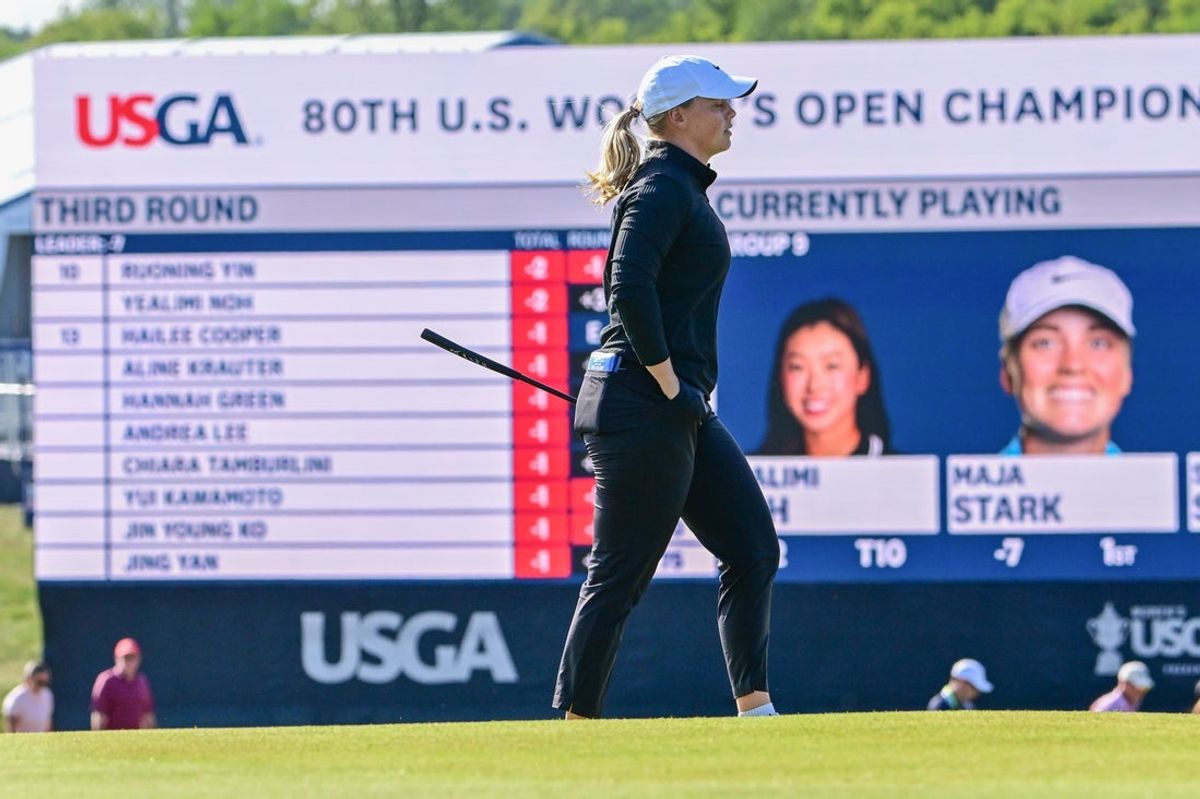 May 31, 2025; Erin, Wisconsin, USA; Maja Stark walks past the leaderboard at the 18th hole during the third round of the U.S. Women's Open golf tournament. Mandatory Credit: Benny Sieu-Imagn Images