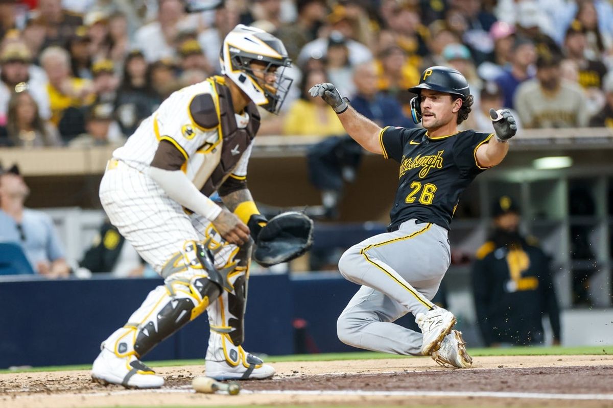 May 31, 2025; San Diego, California, USA; Pittsburgh Pirates second baseman Adam Frazier (26) scores a run during the fourth inning against the San Diego Padres at Petco Park. Mandatory Credit: David Frerker-Imagn Images