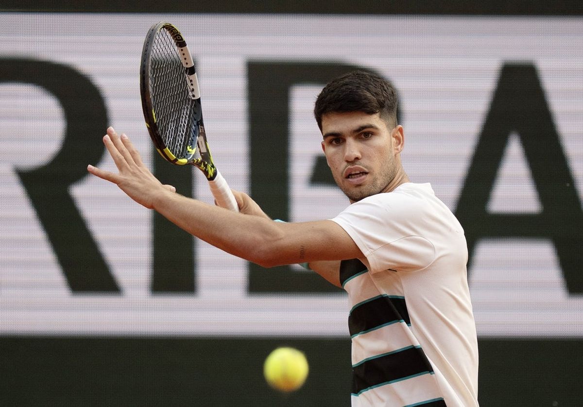 Jun 1, 2025; Paris, FR; Carlos Alcaraz of Spain returns a shot during his match against Ben Shelton of the United States (not pictured) on day eight at Roland Garros Stadium.  Mandatory Credit: Susan Mullane-Imagn Images