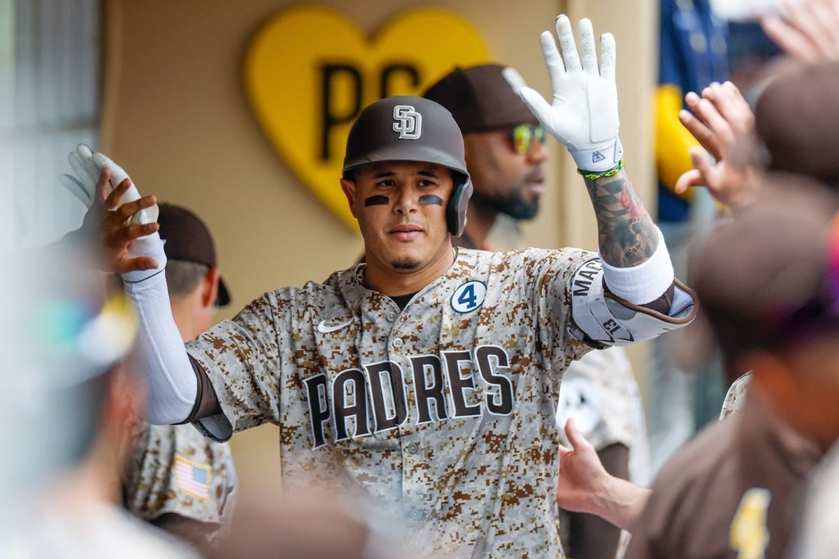 Jun 1, 2025; San Diego, California, USA; San Diego Padres third baseman Manny Machado (13) celebrates in the dugout after hitting a one run home run during the first inning against the Pittsburgh Pirates at Petco Park. Mandatory Credit: David Frerker-Imagn Images
