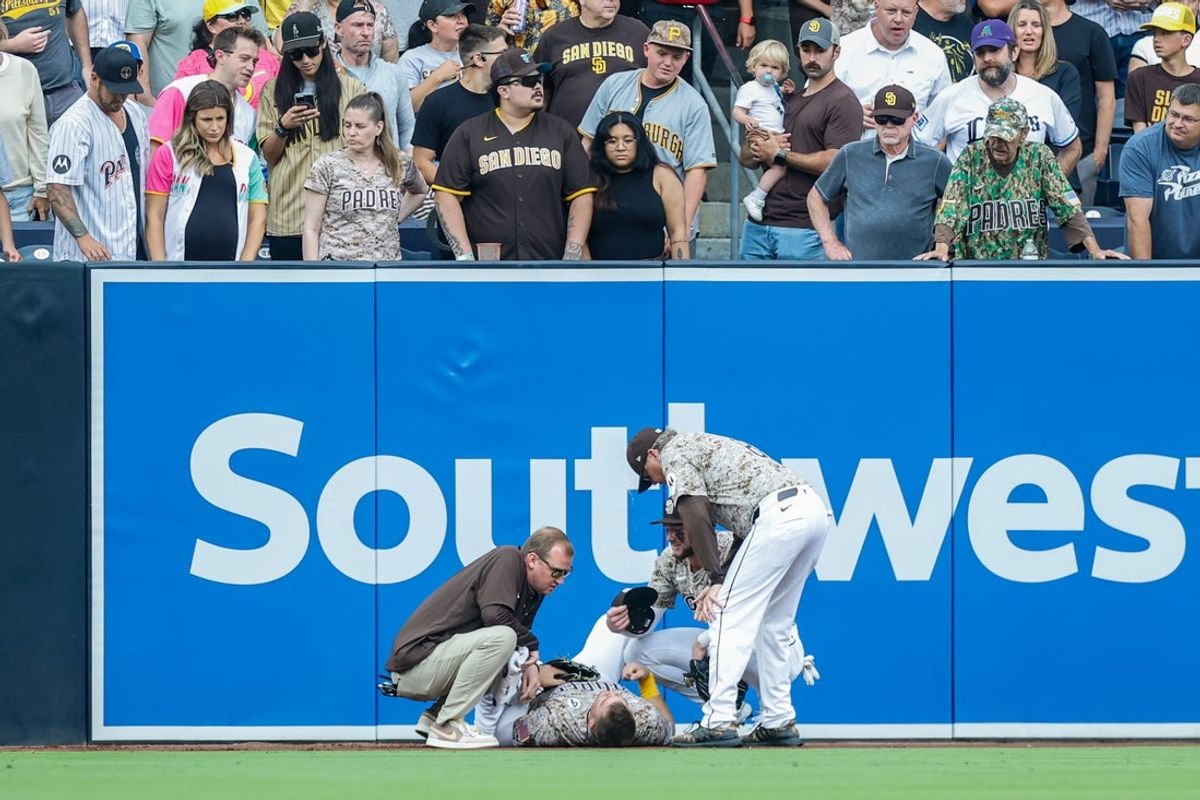 Jun 1, 2025; San Diego, California, USA; San Diego Padres manager Mike Shildt (8) and training staff attend to San Diego Padres left fielder Gavin Sheets (30) during the fourth inning against the Pittsburgh Pirates at Petco Park. Mandatory Credit: David Frerker-Imagn Images
