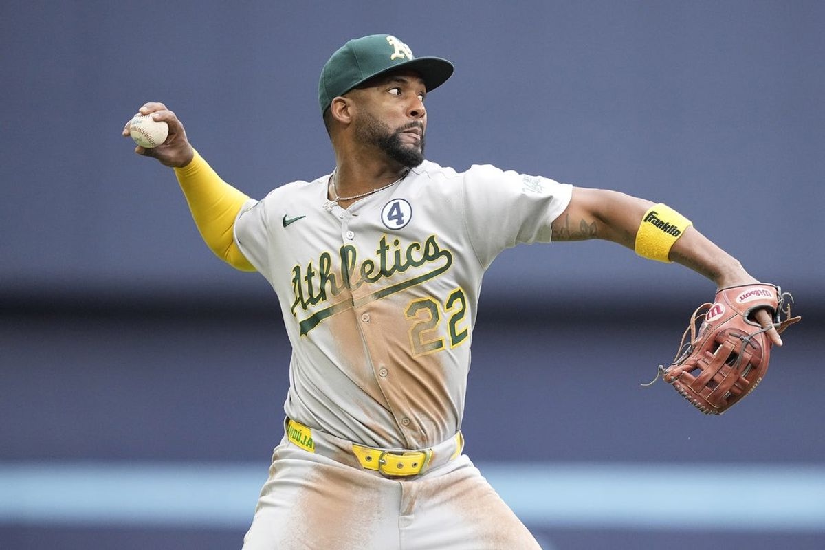 Jun 1, 2025; Toronto, Ontario, CAN; Athletics third baseman Miguel Andujar (22) throws to first base during the third inning against the Toronto Blue Jays at Rogers Centre. Mandatory Credit: John E. Sokolowski-Imagn Images