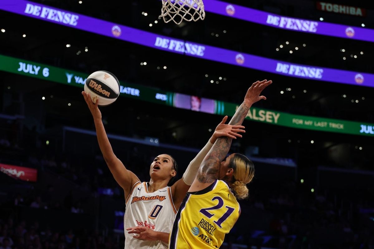 Jun 1, 2025; Los Angeles, California, USA;  Phoenix Mercury forward Satou Sabally (0) shoots the ball against Los Angeles Sparks center Mercedes Russell (21) during the first quarter at Crypto.com Arena. Mandatory Credit: Kiyoshi Mio-Imagn Images