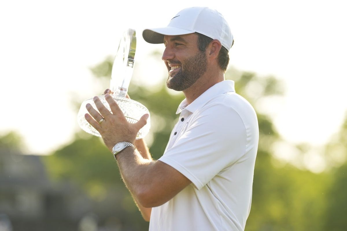 Jun 1, 2025; Dublin, Ohio, USA; Scottie Scheffler poses with the tournament trophy after winning the Memorial Tournament presented by Workday golf tournament. Mandatory Credit: Aaron Doster-Imagn Images