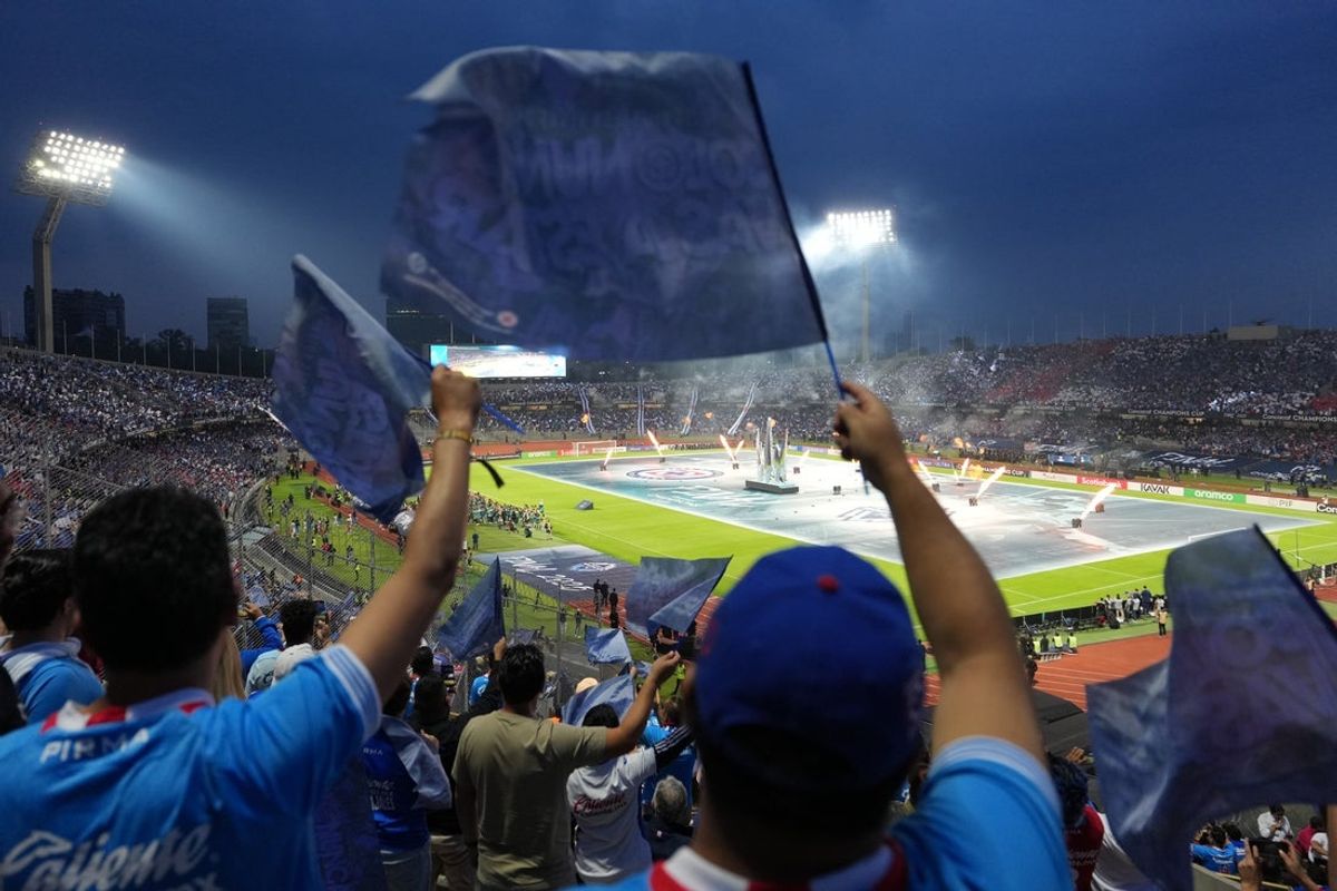 Jun 1, 2025; Mexico City, MEX; Fans wave flags during the opening ceremony prior to the match between Cruz Azul and Vancouver Whitecaps FC during the final of the Concacaf Champions Cup at Estadio Olímpico Universitario. Mandatory Credit: Kirby Lee-Imagn Images
