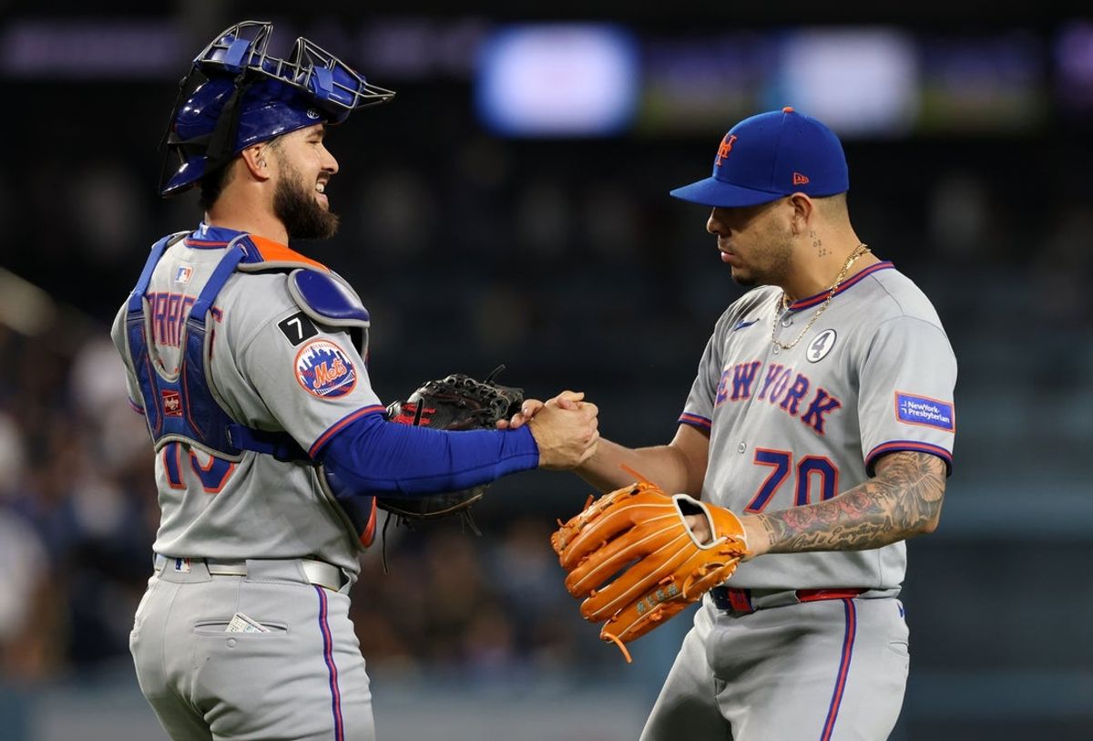 Jun 2, 2025; Los Angeles, California, USA; New York Mets catcher Luis Torrens (13) celebrates with pitcher Jose Butto (70) reacts after defeating the Los Angeles Dodgers at Dodger Stadium. Mandatory Credit: Jason Parkhurst-Imagn Images