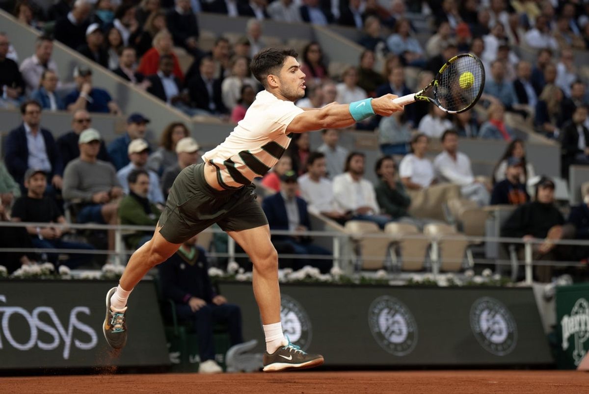 Jun 3, 2025; Paris, FR; Carlos Alcaraz of Spain returns a shot during his match  against Tommy Paul of the United States on day 10 at Roland Garros Stadium.  Mandatory Credit: Susan Mullane-Imagn Images