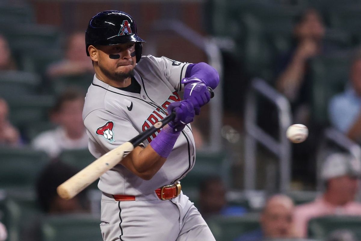 Jun 3, 2025; Atlanta, Georgia, USA; Arizona Diamondbacks catcher Gabriel Moreno (14) hits a single against the Atlanta Braves in the ninth inning at Truist Park. Mandatory Credit: Brett Davis-Imagn Images