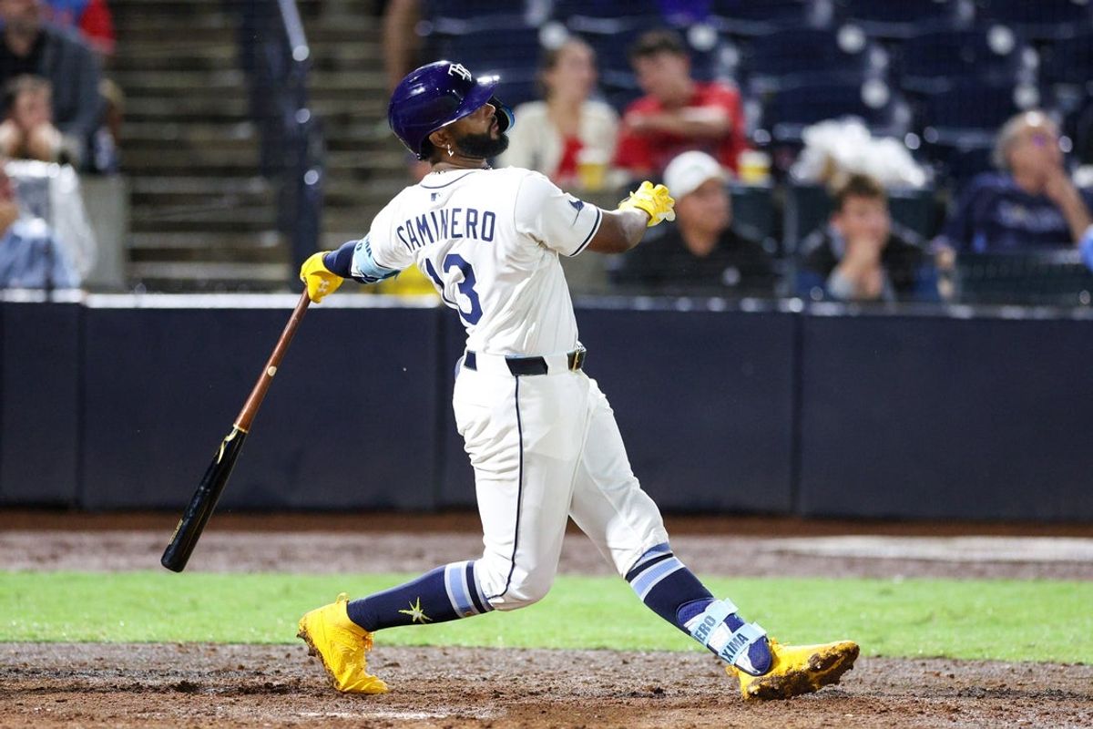 Jun 3, 2025; Tampa, Florida, USA; Tampa Bay Rays third baseman Junior Caminero (13) hits a solo home run against the Texas Rangers in the eighth inning at George M. Steinbrenner Field. Mandatory Credit: Nathan Ray Seebeck-Imagn Images