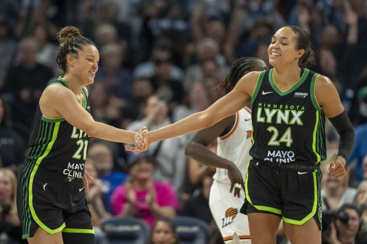 Jun 3, 2025; Minneapolis, Minnesota, USA; Minnesota Lynx guard Kayla McBride (21) celebrates with Minnesota Lynx forward Napheesa Collier (24) after making a shot against the Phoenix Mercury in the second half at Target Center. Mandatory Credit: Jesse Johnson-Imagn Images
