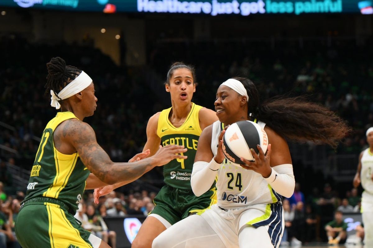 Jun 3, 2025; Seattle, Washington, USA; Dallas Wings guard Arike Ogunbowale (24) drives the ball towards the basket while guarded by Seattle Storm guard Erica Wheeler (17) during the second half at Climate Pledge Arena. Mandatory Credit: Steven Bisig-Imagn Images