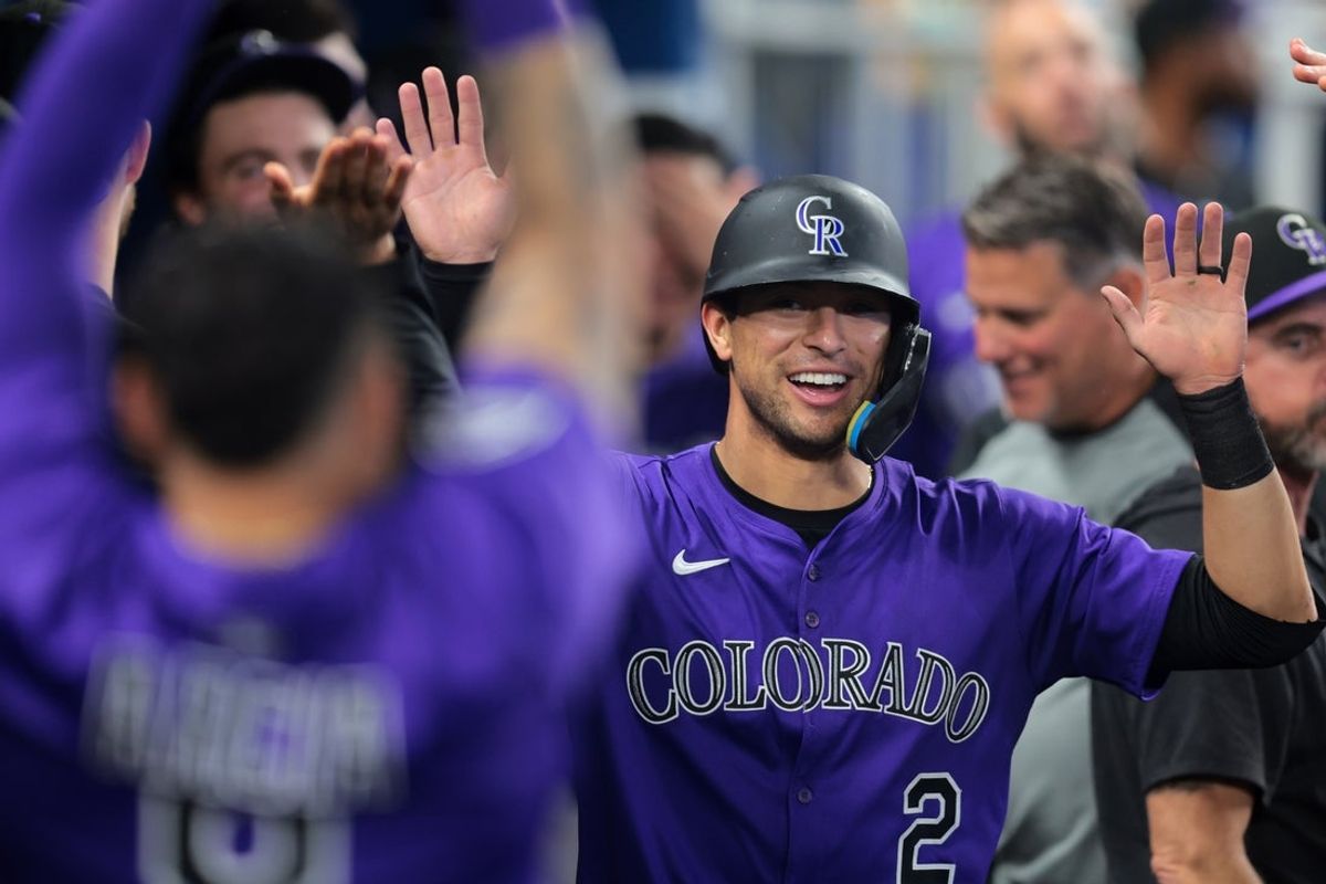 Jun 4, 2025; Miami, Florida, USA; Colorado Rockies right fielder Tyler Freeman (2) celebrates with teammates after scoring against the Miami Marlins during the fifth inning at loanDepot Park. Mandatory Credit: Sam Navarro-Imagn Images