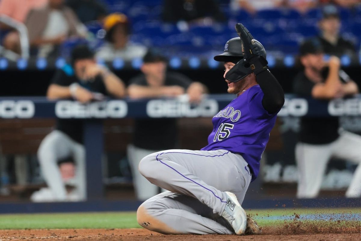 Jun 4, 2025; Miami, Florida, USA; Colorado Rockies catcher Hunter Goodman (15) slides at home plate and scores against the Miami Marlins during the sixth inning at loanDepot Park. Mandatory Credit: Sam Navarro-Imagn Images