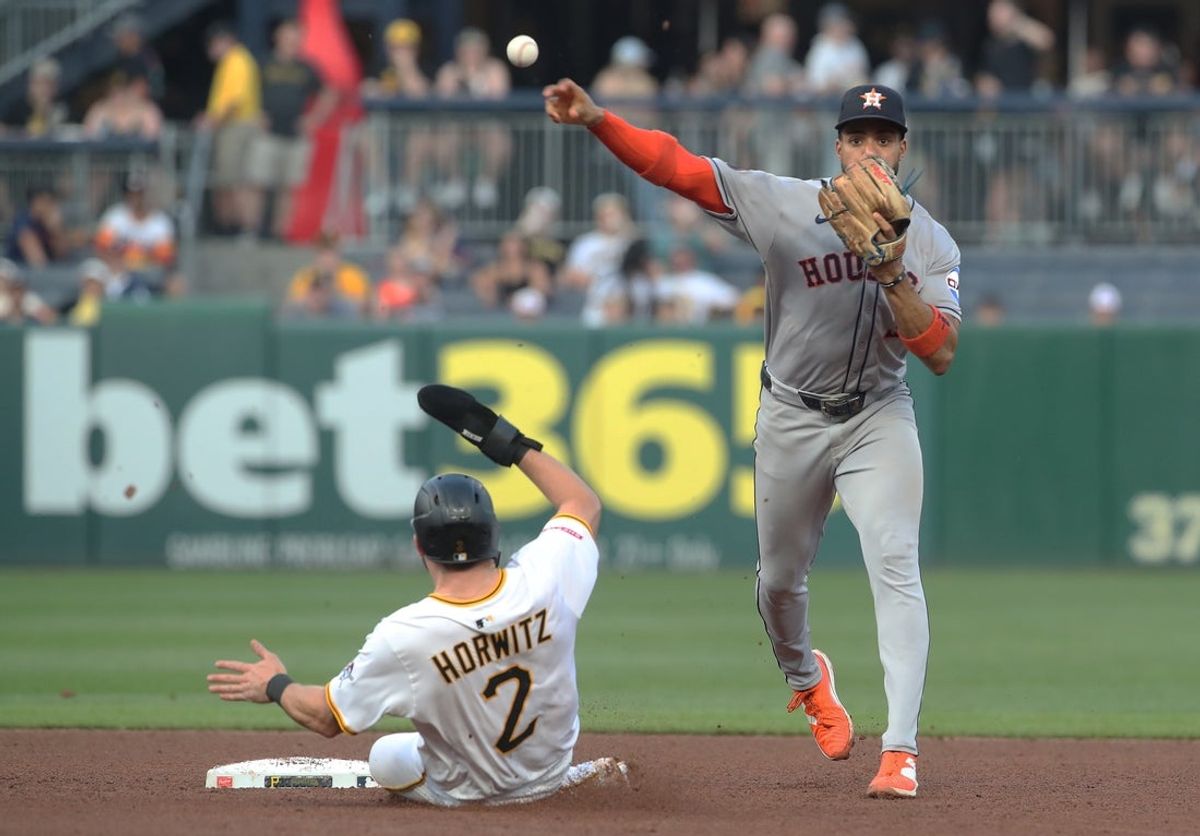 Jun 4, 2025; Pittsburgh, Pennsylvania, USA;  Houston Astros shortstop Jeremy Pena (3) turns a double play over Pittsburgh Pirates first baseman Spencer Horwitz (2) during the fifth inning at PNC Park. Mandatory Credit: Charles LeClaire-Imagn Images
