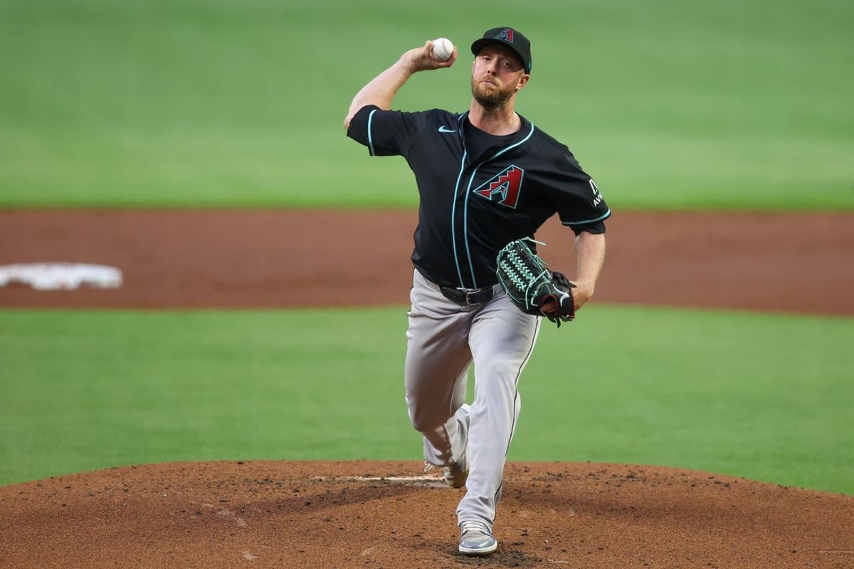 Jun 4, 2025; Atlanta, Georgia, USA; Arizona Diamondbacks starting pitcher Merrill Kelly (29) throws against the Atlanta Braves in the first inning at Truist Park. Mandatory Credit: Brett Davis-Imagn Images