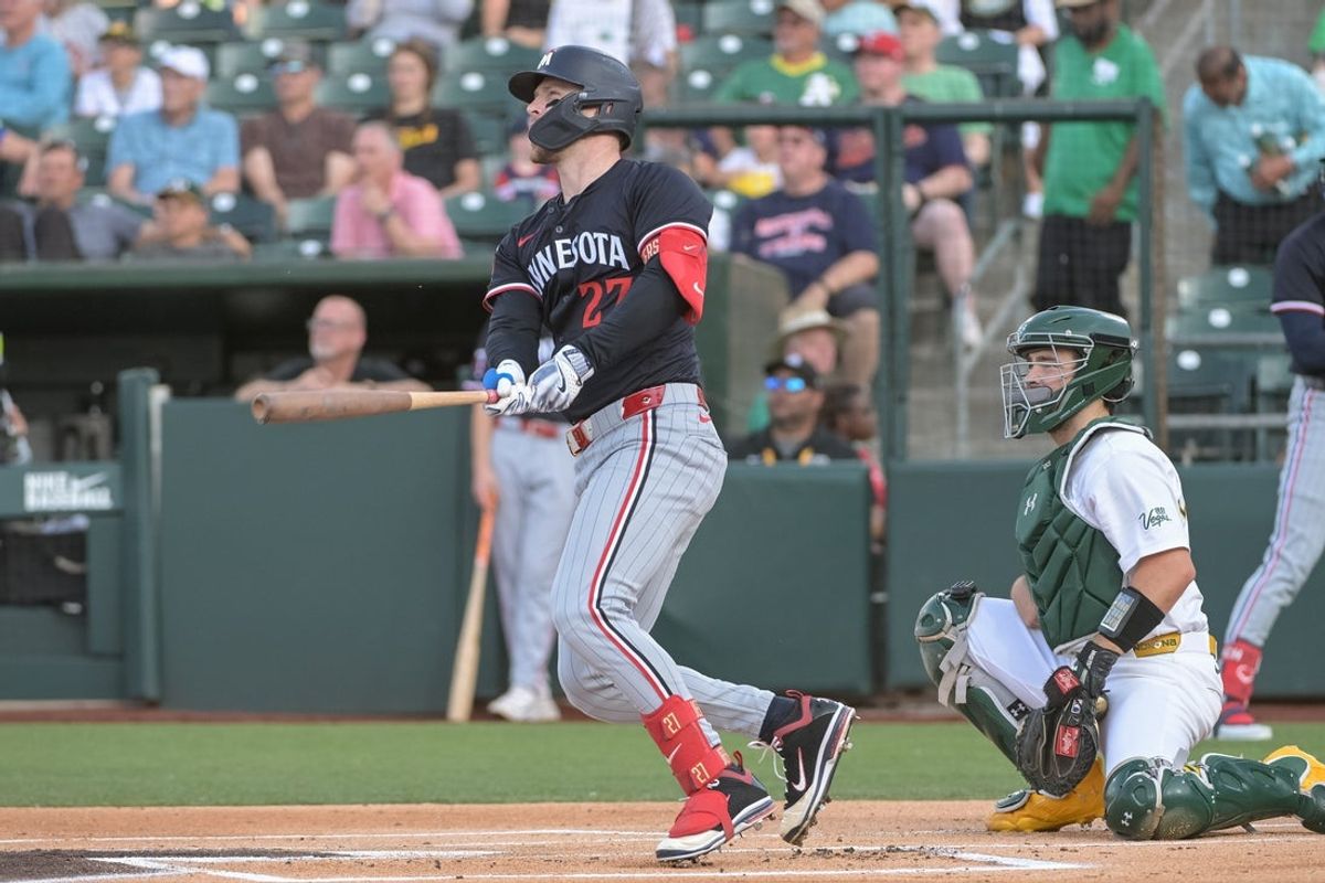 Jun 4, 2025; West Sacramento, California, USA; Minnesota Twins catcher Ryan Jeffers (27) hits a home run against the Athletics during the first inning at Sutter Health Park. Mandatory Credit: Ed Szczepanski-Imagn Images