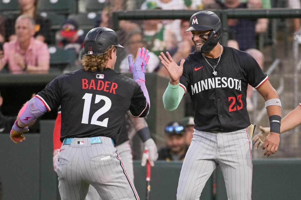 Jun 4, 2025; West Sacramento, California, USA; Minnesota Twins outfielder Harrison Bader (12) celebrates with third base Royce Lewis (23) after hitting a home run against the Athletics during the fifth inning at Sutter Health Park. Mandatory Credit: Ed Szczepanski-Imagn Images