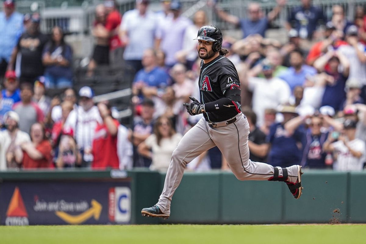 Jun 5, 2025; Cumberland, Georgia, USA; Arizona Diamondbacks third baseman Eugenio Suarez (28) runs after hitting a double to drive in two runs against the Atlanta Braves during the ninth inning at Truist Park. Mandatory Credit: Dale Zanine-Imagn Images