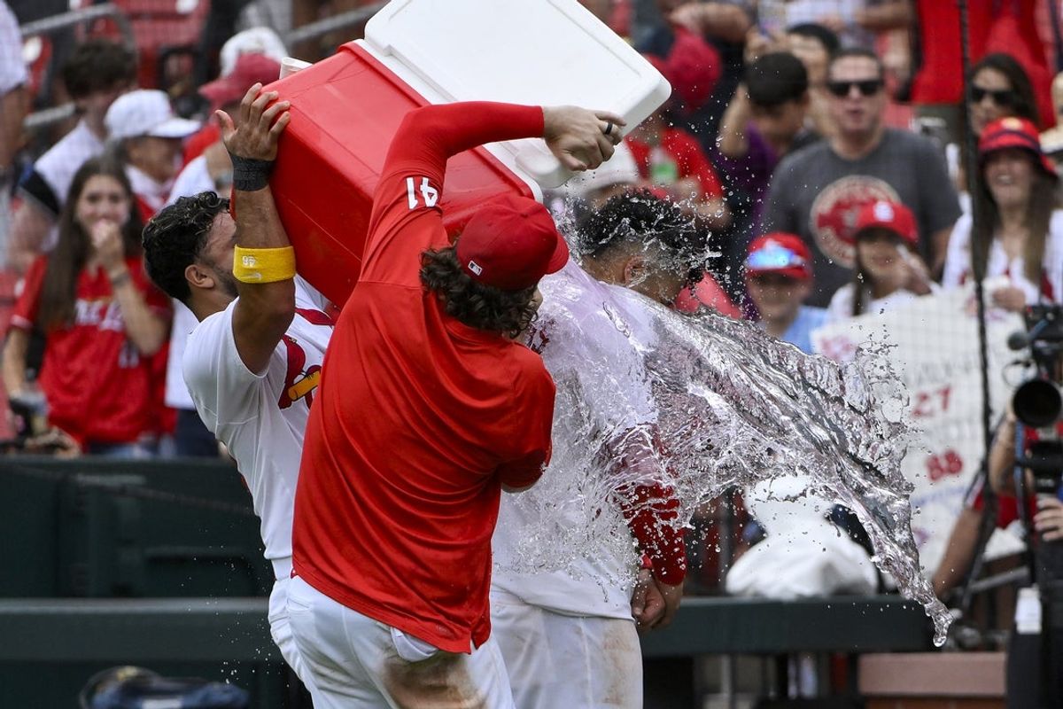 Jun 5, 2025; St. Louis, Missouri, USA;  St. Louis Cardinals first baseman Willson Contreras (40) is doused with water by designated hitter Ivan Herrera (48) and left fielder Alec Burleson (41) after hitting a walk-off one run single against the Kansas City Royals during the tenth inning at Busch Stadium. Mandatory Credit: Jeff Curry-Imagn Images