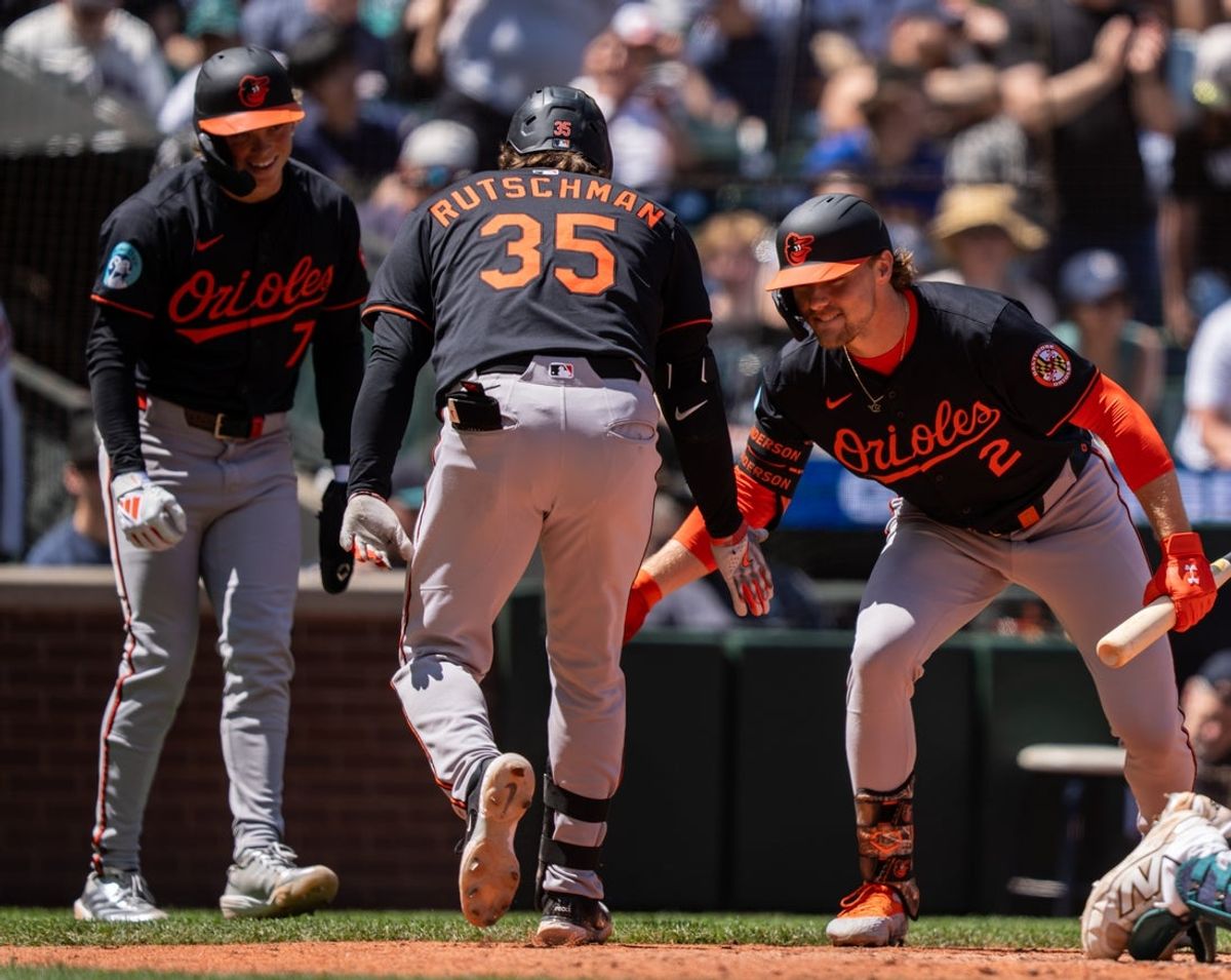 Jun 5, 2025; Seattle, Washington, USA;  Balitimore Orioles designated hitter Adley Rutschman (35) is congratulated by shortstop Gunnar Henderson (2) and second baseman Jackson Holliday (7) after hitting two-run home run during the sixth inning against the Seattle Mariners at T-Mobile Park. Mandatory Credit: Stephen Brashear-Imagn Images