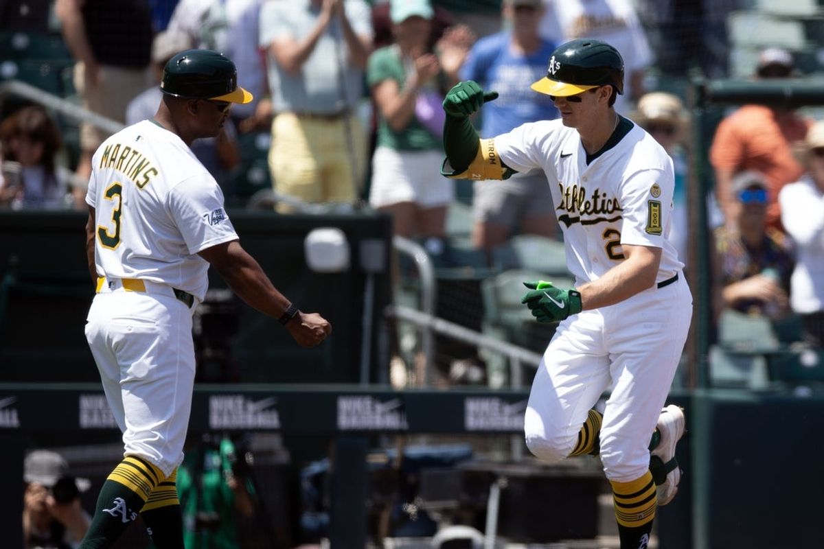 Jun 5, 2025; West Sacramento, California, USA; Athletics first baseman Tyler Soderstrom (21) gets a congratulatory handshake from third base coach Eric Martins (3) after hitting a grand slam against the Minnesota Twins during the fourth inning at Sutter Health Park. Mandatory Credit: D. Ross Cameron-Imagn Images