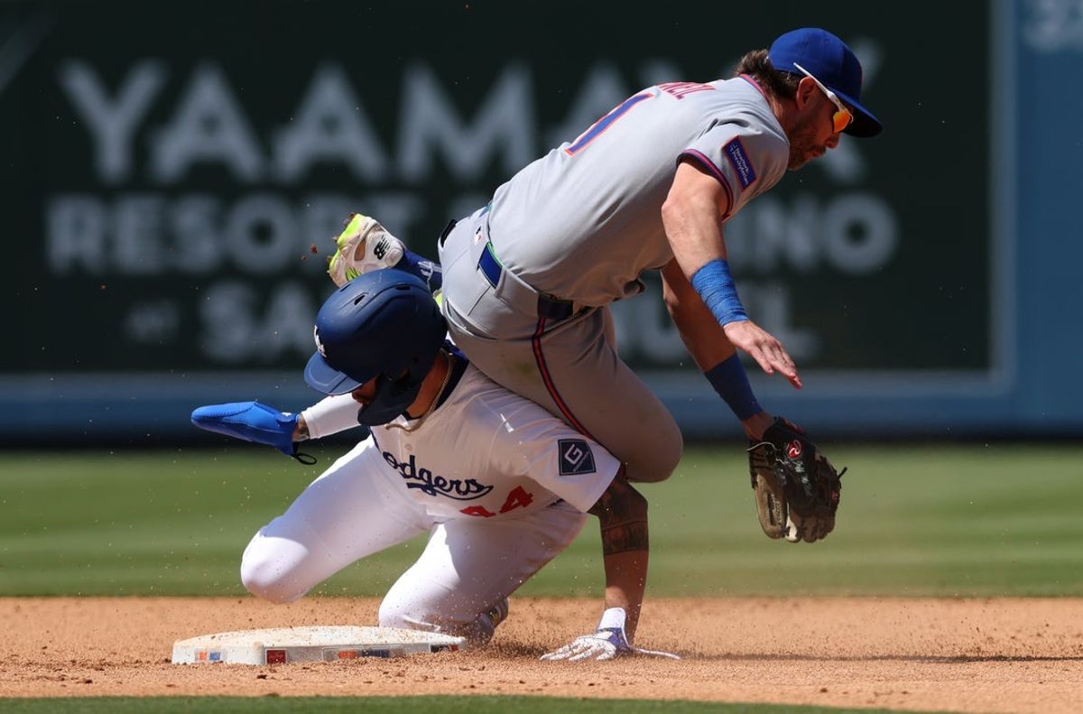 Jun 5, 2025; Los Angeles, California, USA; New York Mets second baseman Jeff McNeil (1) is upended by Los Angeles Dodgers outfielder Andy Pages (44) after turning a double play during the sixth inning at Dodger Stadium. Mandatory Credit: Jason Parkhurst-Imagn Images