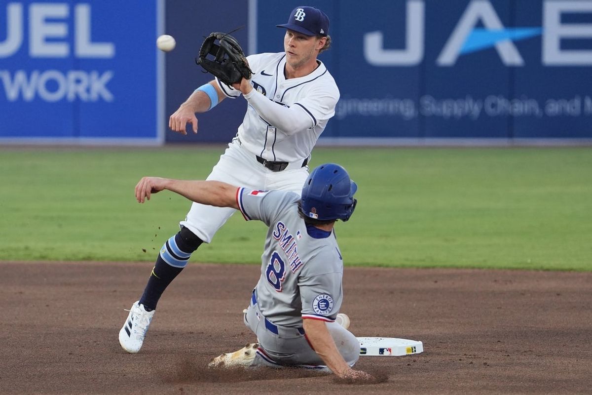 Jun 5, 2025; Tampa, Florida, USA; Tampa Bay Rays shortstop Taylor Walls (6) tags out Texas Rangers shortstop Josh Smith (8) as he tries to steal second base during the first inning at George M. Steinbrenner Field. Mandatory Credit: Dave Nelson-Imagn Images
