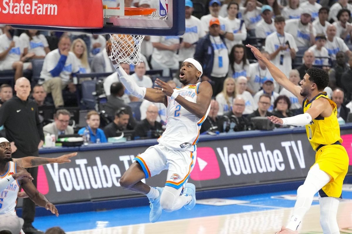 Oklahoma City Thunder guard Shai Gilgeous-Alexander (2) drives to the basket past Indiana Pacers guard Tyrese Haliburton (0) during the first quarter during game one of the 2025 NBA Finals at Paycom Center. Mandatory Credit: Kyle Terada-Imagn Images