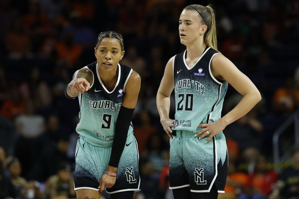Jun 5, 2025; Washington, District of Columbia, USA; New York Liberty guard Natasha Cloud (9) talks with Liberty guard Sabrina Ionescu (20) against the Washington Mystics in the first half at Entertainment & Sports Arena. Mandatory Credit: Geoff Burke-Imagn Images