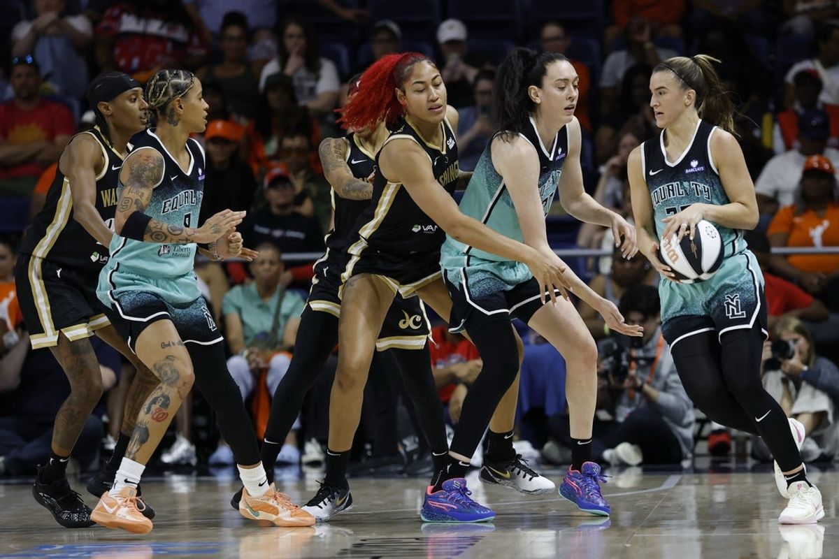 Jun 5, 2025; Washington, District of Columbia, USA; New York Liberty forward Breanna Stewart (30) hands the ball off to Liberty guard Sabrina Ionescu (20) as Washington Mystics forward Shakira Austin (0) defends in the second half at Entertainment & Sports Arena. Mandatory Credit: Geoff Burke-Imagn Images