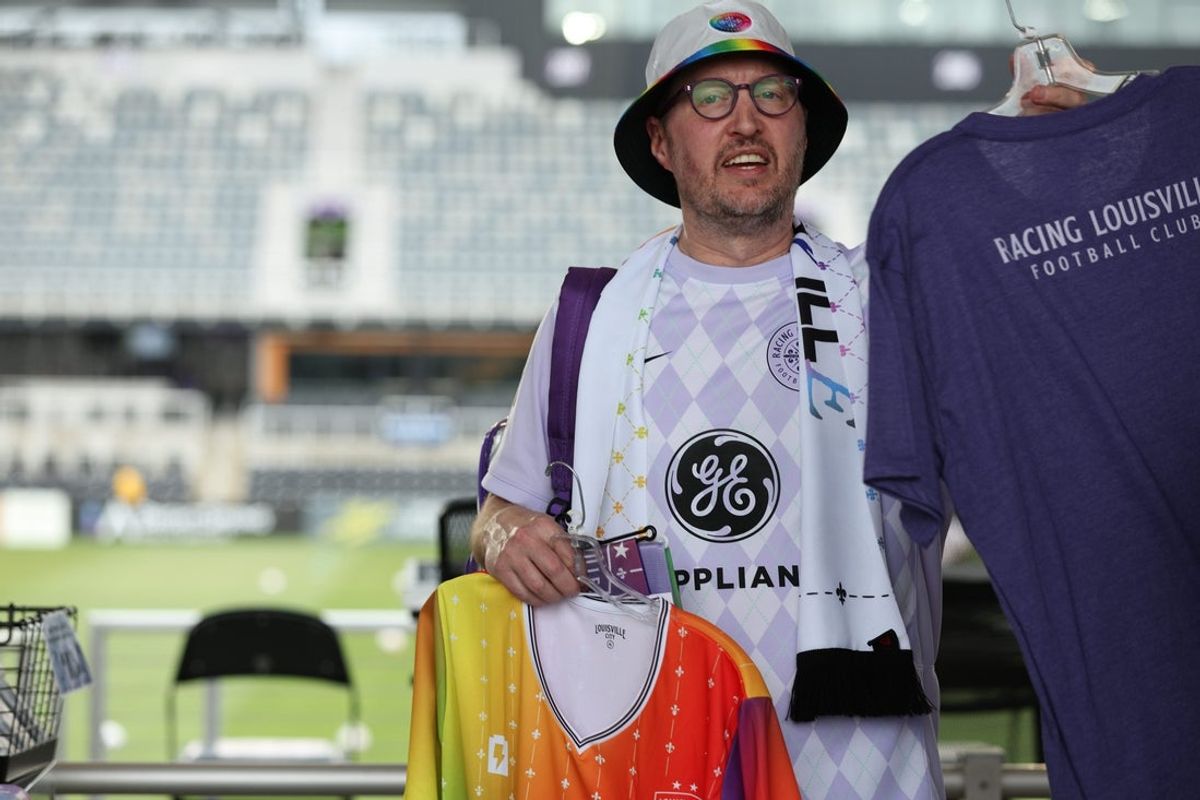 Jun 6, 2025; Louisville, Kentucky, USA;  A fan buys Racing Louisville FC merchandise for Pride night before the game against Utah Royals at Lynn Family Stadium. Mandatory Credit: EM Dash-Imagn Images