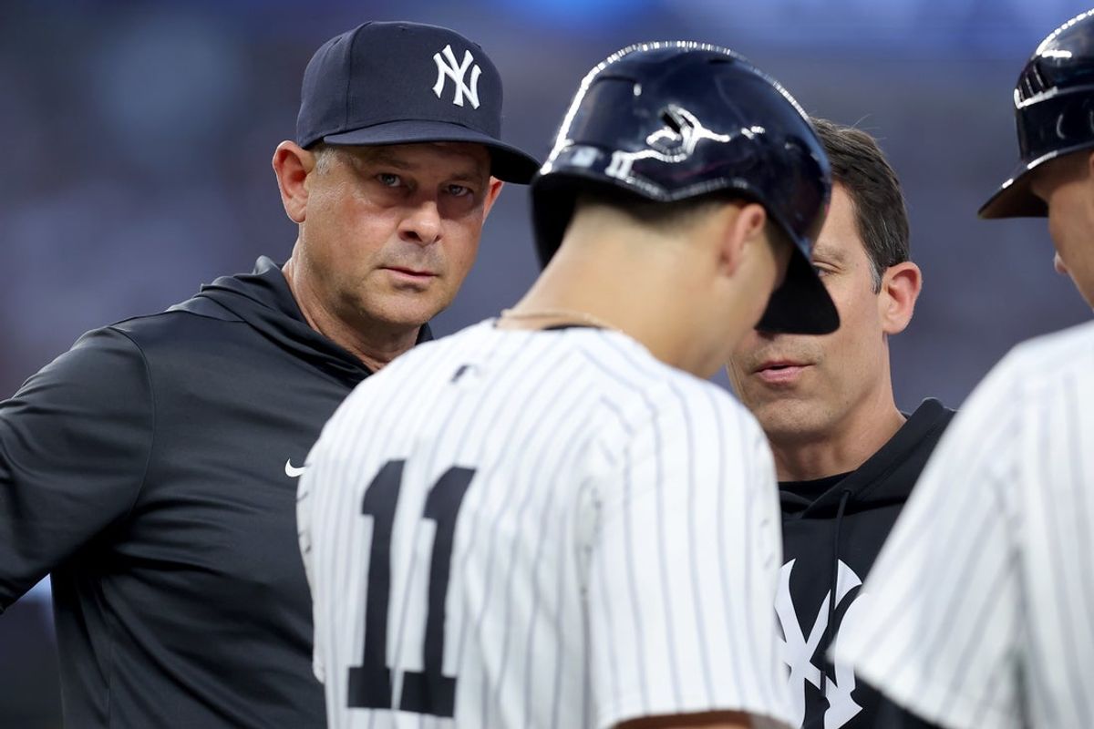 Jun 6, 2025; Bronx, New York, USA; New York Yankees manager Aaron Boone (17) checks on shortstop Anthony Volpe (11) after Volpe was hit by a pitch during the second inning against the Boston Red Sox at Yankee Stadium. Mandatory Credit: Brad Penner-Imagn Images