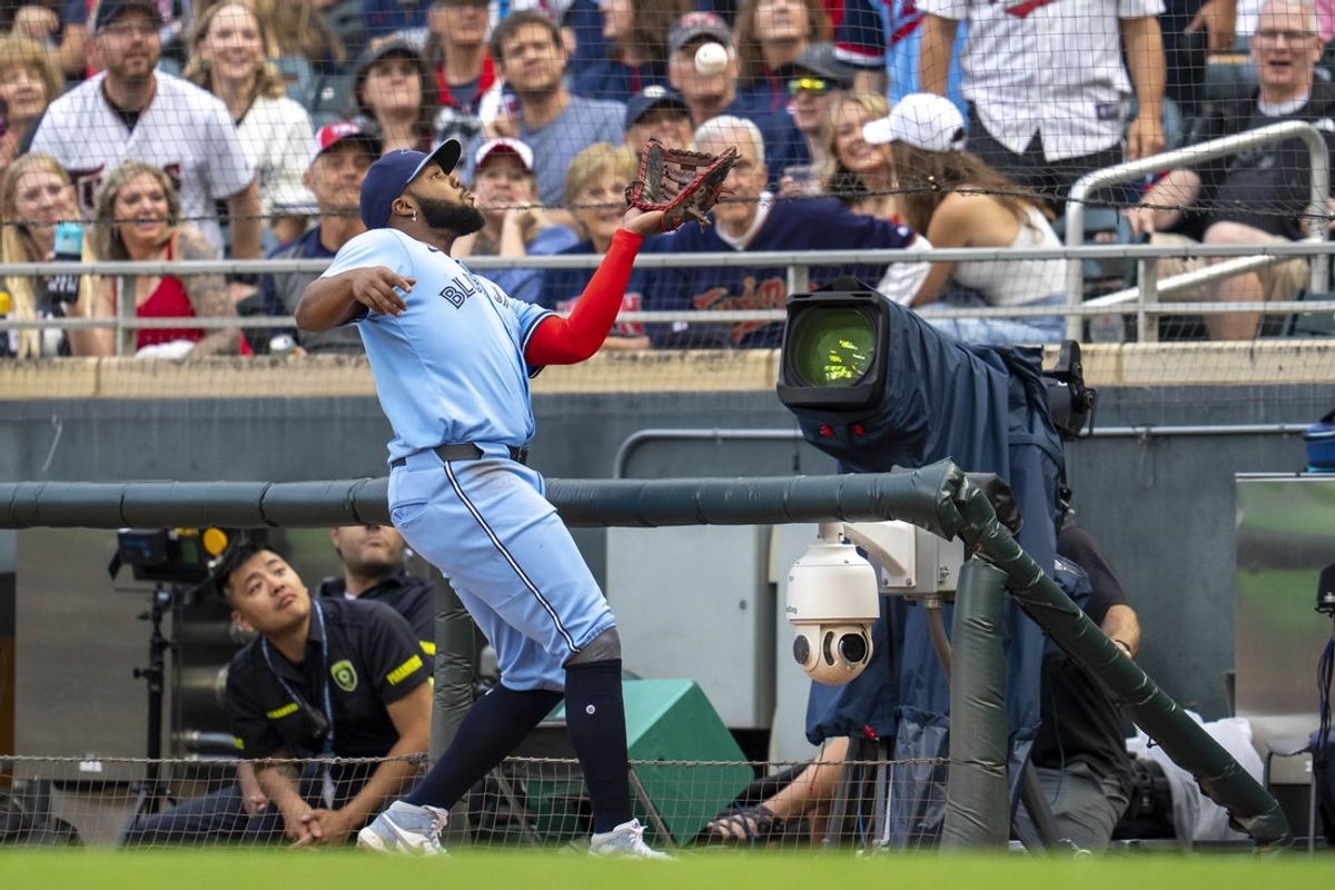 Jun 6, 2025; Minneapolis, Minnesota, USA; Toronto Blue Jays first baseman Vladimir Guerrero Jr. (27) catches a foul ball for an out against the Minnesota Twins in the first inning at Target Field. Mandatory Credit: Jesse Johnson-Imagn Images