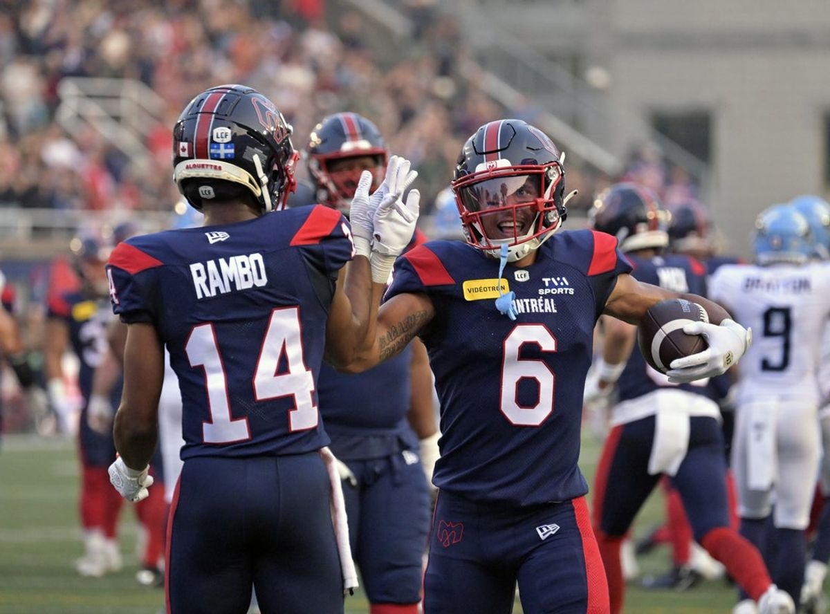 Jun 6, 2025; Montreal, Quebec, Canada; Montreal Alouettes wide receiver Tyson Philpot (6) celebrates with teammate wide receiver Charleston Rambo (14) after scoring a touchdown against the Toronto Argonauts during the first half at Percival-Molson stadium. Mandatory Credit: Eric Bolte-Imagn Images