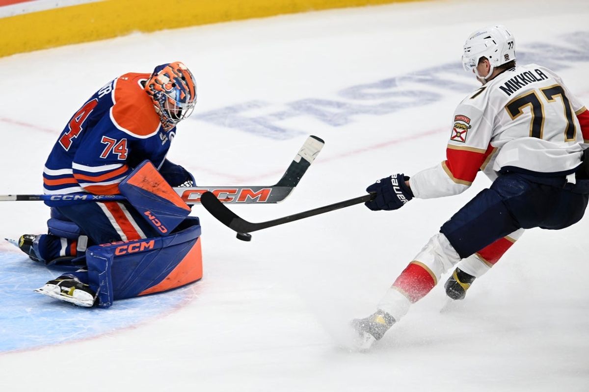 Jun 6, 2025; Edmonton, Alberta, CAN; Florida Panthers defenseman Niko Mikkola (77) shoots on Edmonton Oilers goaltender Stuart Skinner (74) during the second period in game two of the 2025 Stanley Cup Final at Rogers Place. Mandatory Credit: Walter Tychnowicz-Imagn Images