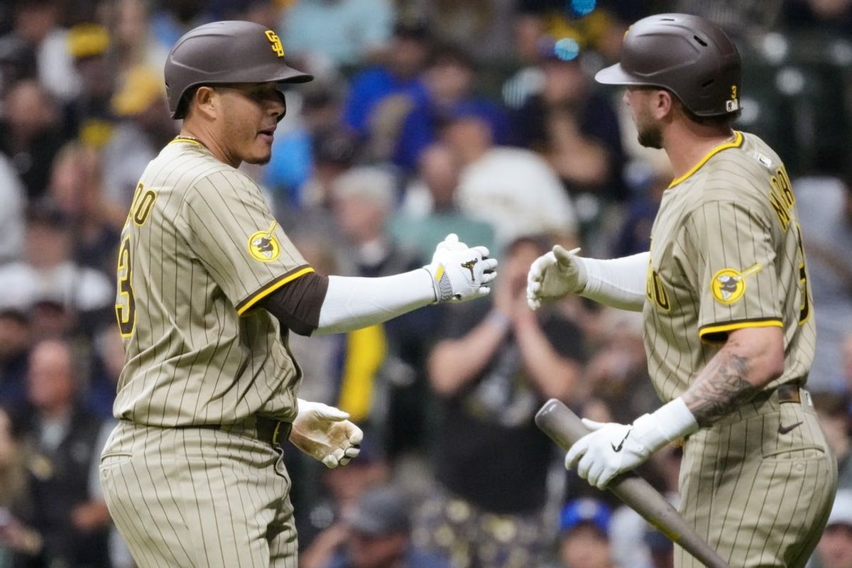 Jun 6, 2025; Milwaukee, Wisconsin, USA;  San Diego Padres third baseman Manny Machado (13) celebrates with center fielder Jackson Merrill (3) after hitting a home run during the eighth inning against the Milwaukee Brewers at American Family Field. Mandatory Credit: Jeff Hanisch-Imagn Images