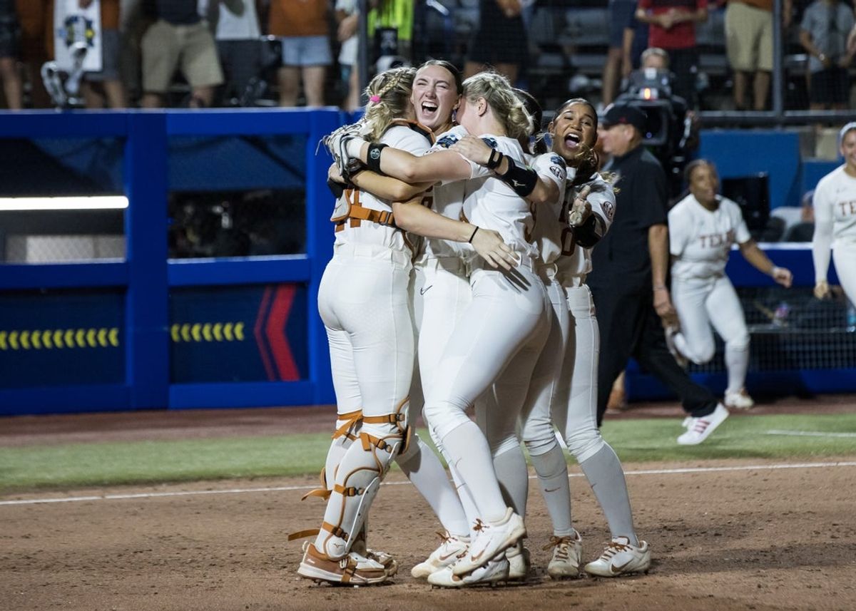 Jun 6, 2025; Oklahoma City, OK, USA;  Texas Longhorns pitcher Teagan Kavan (17) is hugged by utility Reese Atwood (14) and infielder Joley Mitchell (9) and utility Mia Scott (10) celebrating their win over the Texas Tech Red Raiders 10-4 to win the National Championship in game three of the NCAA Softball Women's College World Series finals at Devon Park. Mandatory Credit: Brett Rojo-Imagn Images