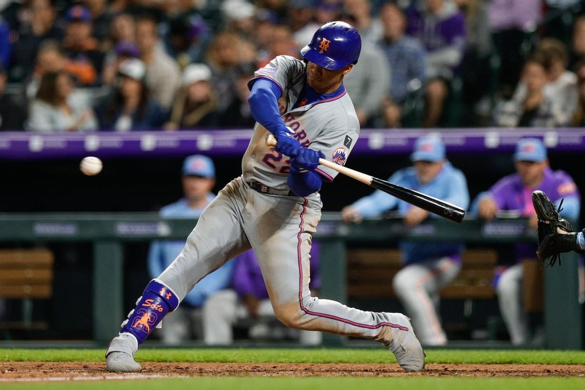 Jun 6, 2025; Denver, Colorado, USA; New York Mets right fielder Juan Soto (22) hits a single in the seventh inning against the Colorado Rockies at Coors Field. Mandatory Credit: Isaiah J. Downing-Imagn Images