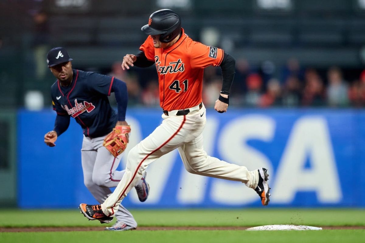 Jun 6, 2025; San Francisco, California, USA; San Francisco Giants first baseman Wilmer Flores (41) runs toward third base against Atlanta Braves second baseman Ozzie Albies (1) during the fifth inning at Oracle Park. Mandatory Credit: Robert Edwards-Imagn Images