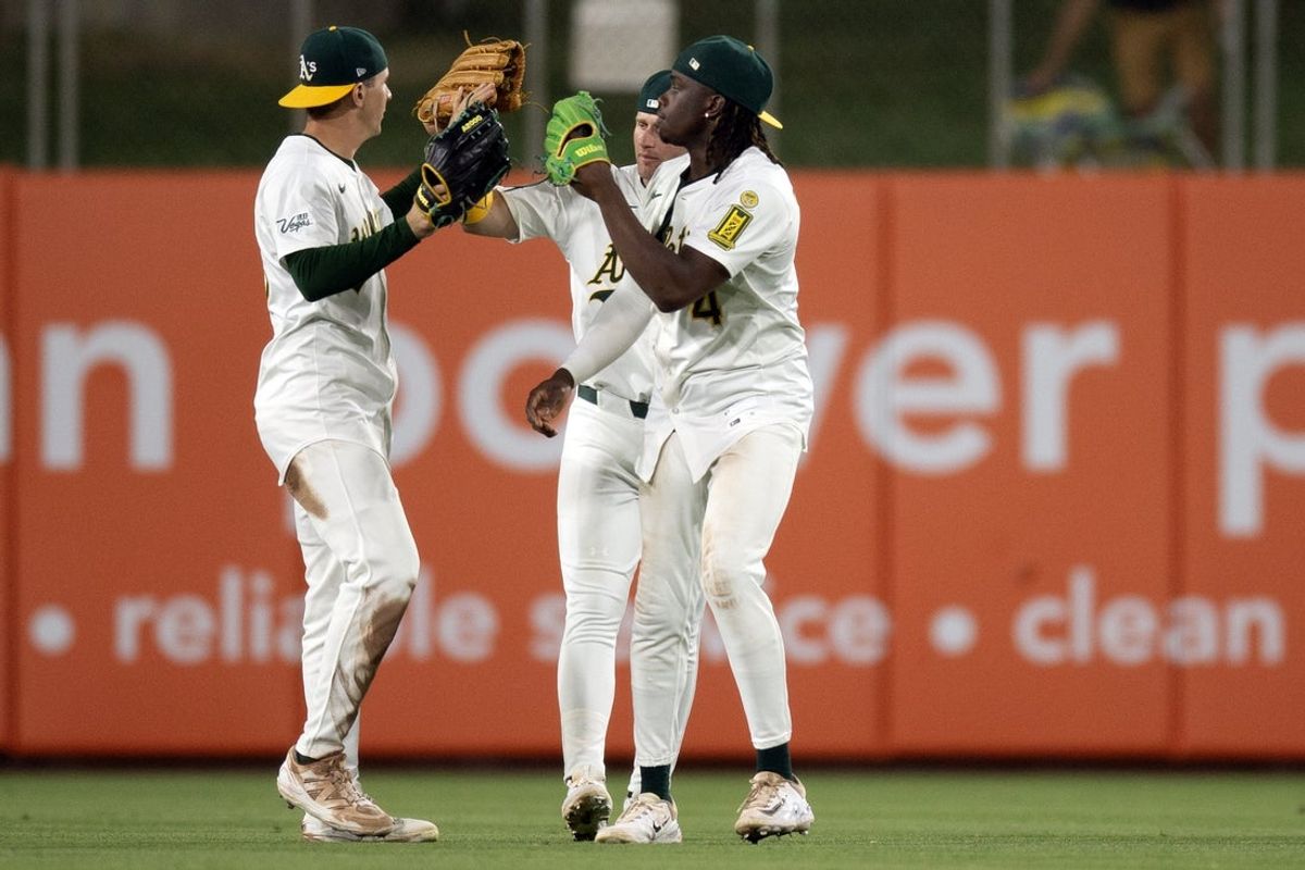 Jun 6, 2025; West Sacramento, California, USA; Athletics outfielders JJ Bleday (33), Seth Brown and Lawrence Butler celebrate their 5-4 victory over the Baltimore Orioles at Sutter Health Park. Mandatory Credit: D. Ross Cameron-Imagn Images