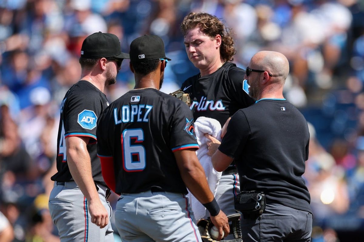 Jun 7, 2025; Tampa, Florida, USA; Miami Marlins starting pitcher Ryan Weathers (35) is attended to by training staff after being hit in the head by an errant throw from Miami Marlins catcher Nick Fortes (4) (not pictured) against the Tampa Bay Rays in the first inning at George M. Steinbrenner Field. Mandatory Credit: Nathan Ray Seebeck-Imagn Images