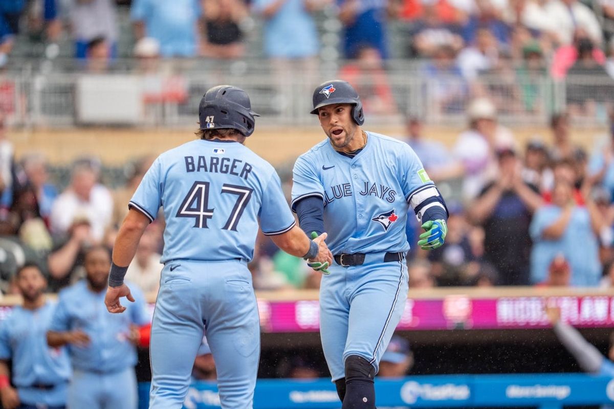 Jun 7, 2025; Minneapolis, Minnesota, USA; Toronto Blue Jays outfielder George Springer (4) crosses home plate after hitting a home run to score Toronto Blue Jays third base Addison Barger (47) off Minnesota Twins pitcher Griffin Jax (22) in the eithth inning at Target Field. Mandatory Credit: Matt Blewett-Imagn Images