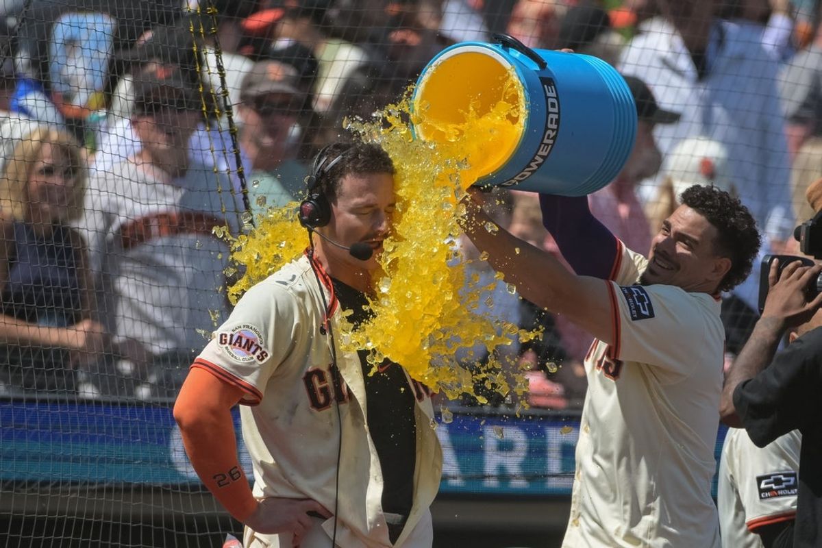 Jun 7, 2025; San Francisco, California, USA;  San Francisco Giants third baseman Matt Chapman (26) is doused with Gatorade after hitting a walk off home run against the Atlanta Braves during the ninth inning at Oracle Park. Mandatory Credit: Ed Szczepanski-Imagn Images