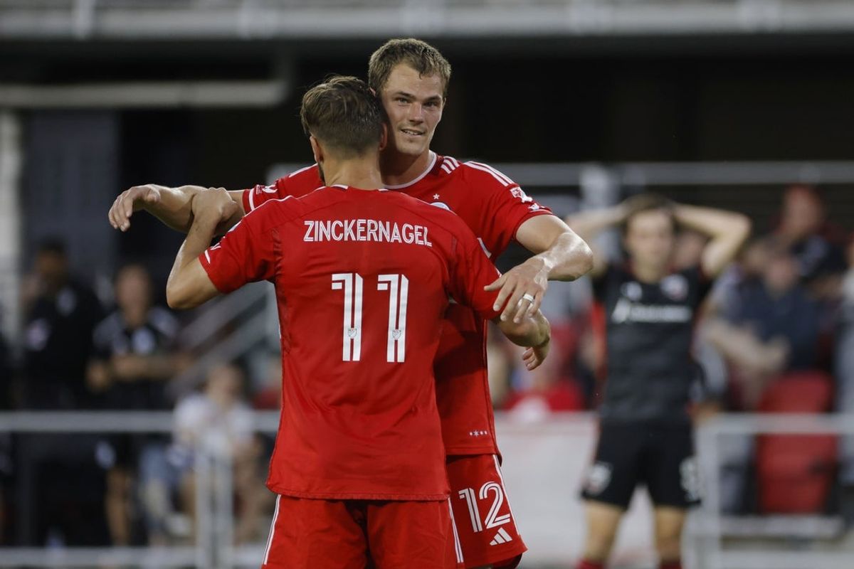 Jun 7, 2025; Washington, District of Columbia, USA; Chicago Fire forward Tom Barlow (12) celebrates with Fire forward Philip Zinckernagel (11) after scoring a goal against the D.C. United during the first half at Audi Field. Mandatory Credit: Amber Searls-Imagn Images